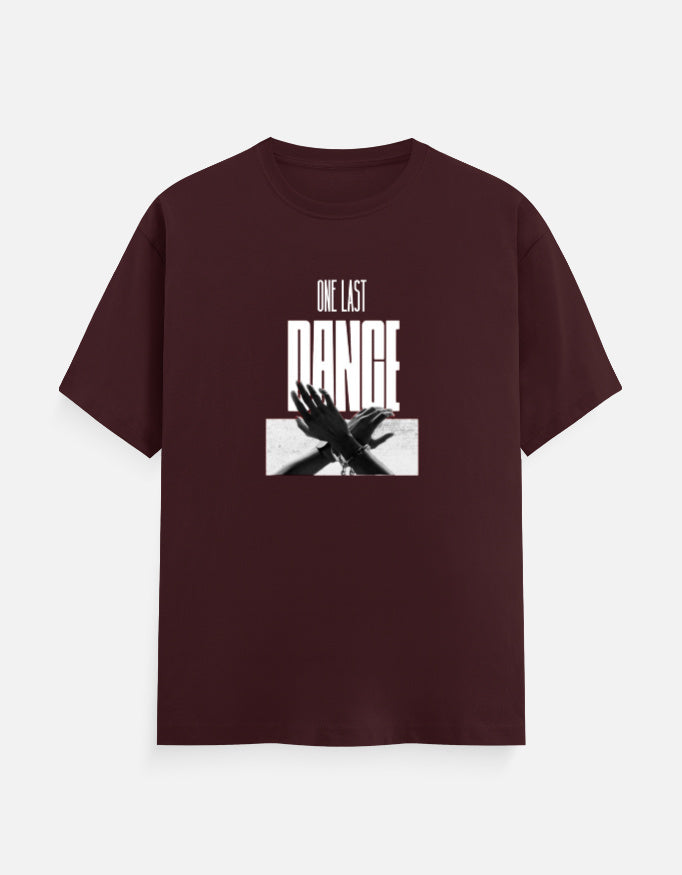 A maroon premium cotton graphic t-shirt featuring the "One Last Dance" typography with a monochrome artistic hand illustration on the front. Ideal for casual and streetwear fashion.