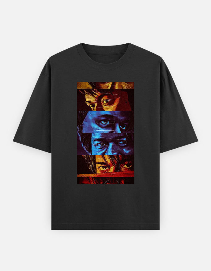 A black oversized premium cotton t-shirt featuring a bold multi-color eye collage graphic print on the front. Modern unisex streetwear by LowKey.