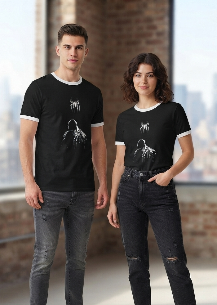 Model wearing black ringer t-shirt with white contrast collar and glowing spider silhouette graphic print, front view