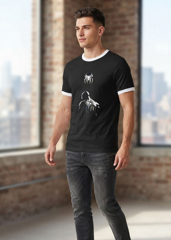 Model wearing black ringer t-shirt with white contrast collar and glowing spider silhouette graphic print, front view