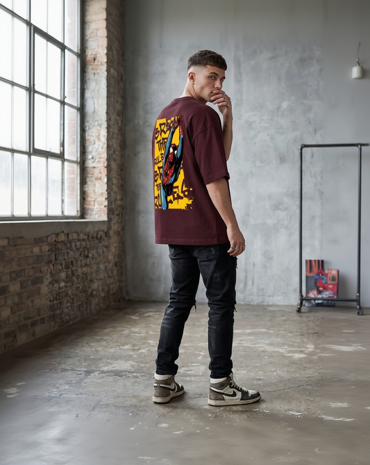 Model wearing Large yellow rectangular graphic on the back of a maroon t-shirt featuring a comic-style Spider-Man and "Break the Rules" graffiti text.