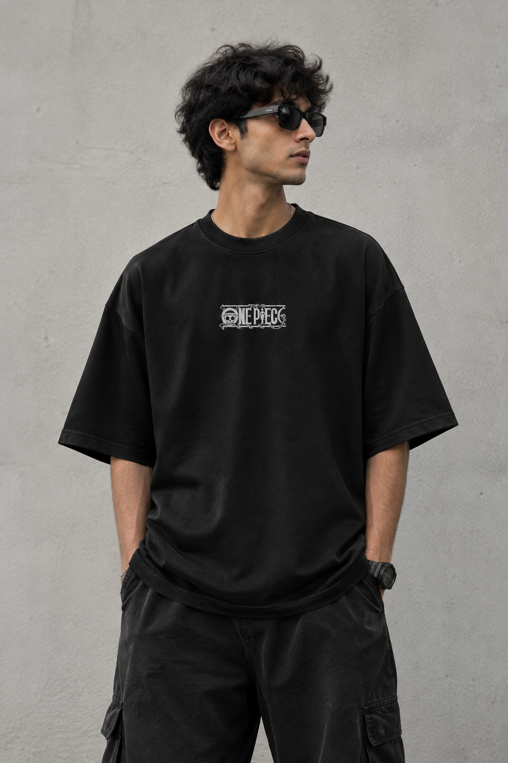 Model wearing Black oversized T-shirt with minimal graphic chest print
