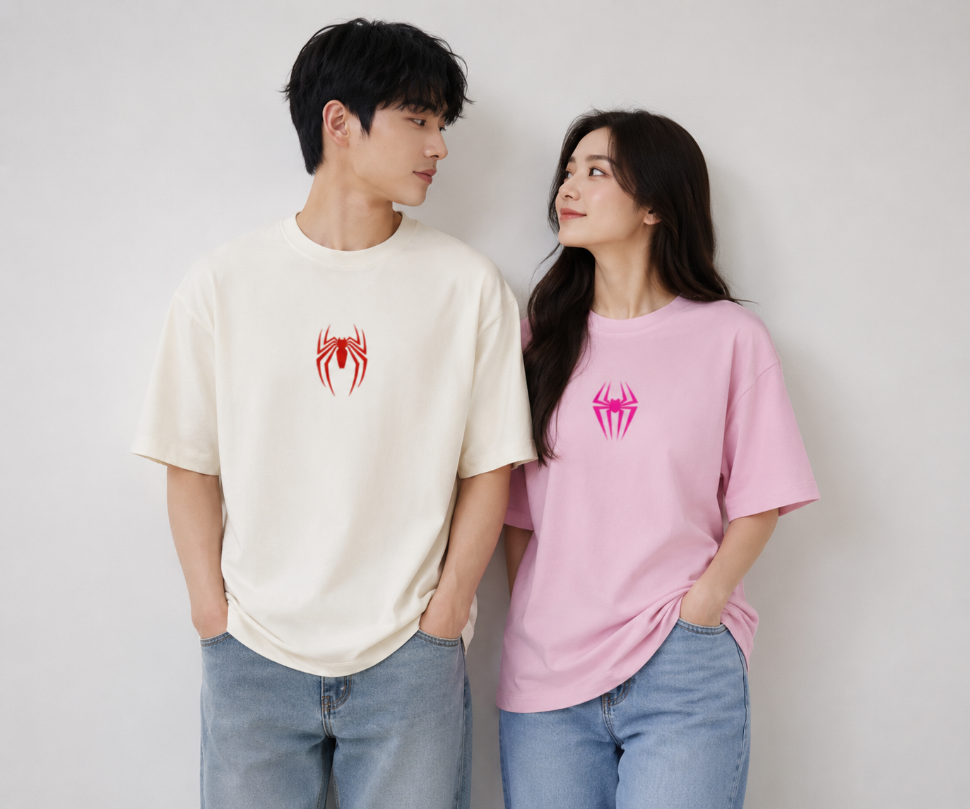 Couple wearing Spider-Man oversized t-shirt and Spider-Gwen oversized t-shirt with front spider logo