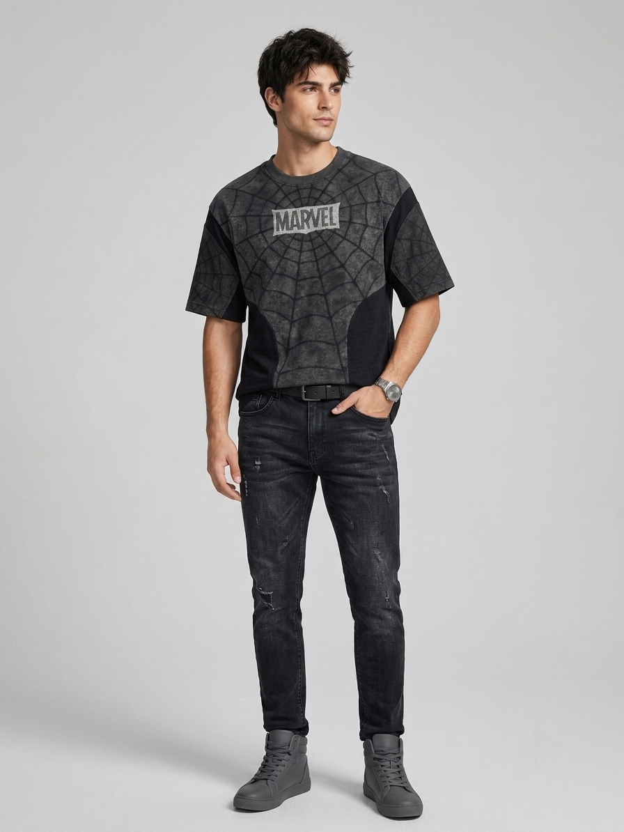 Man wearing Spider-Man web print oversized black t-shirt with Marvel logo, front view