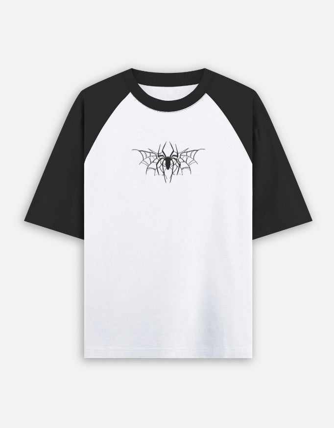 Black and white oversized raglan t-shirt with spider web graphic print on chest, front view